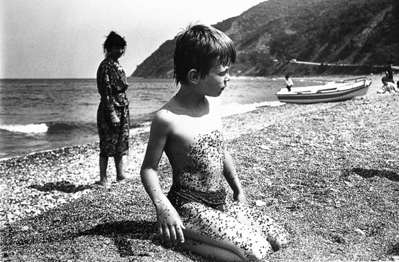 Boy and Pebbles on Beach