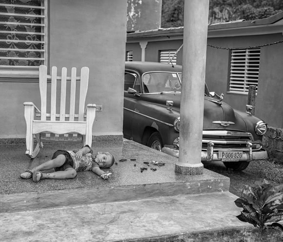 Cuban Child Playing on his Porch