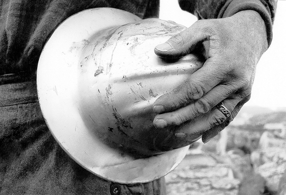 Logger's hand with helmet Logger's hand with helmet