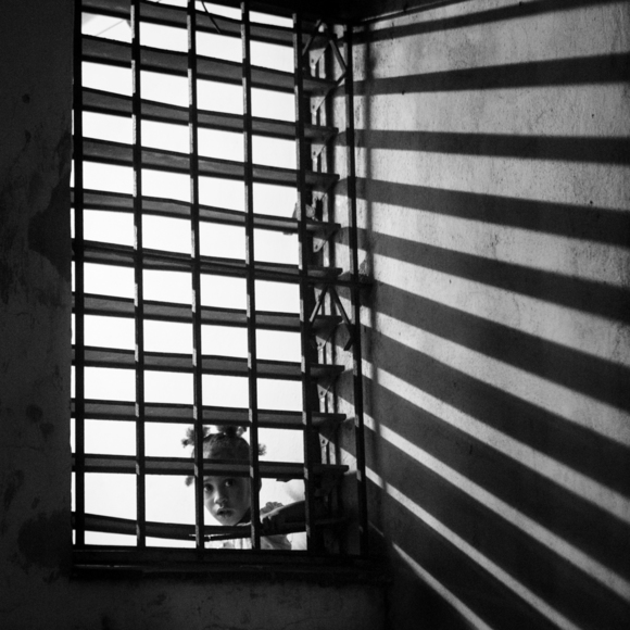 Cuban Girl Looking Out from Behind Bars
