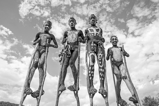 Four Boys On Stilts