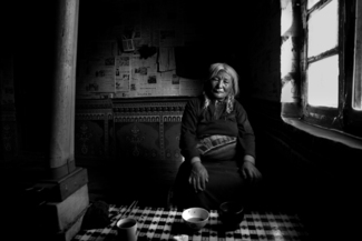 Tibetan Woman Kneeling