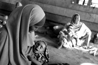 Mother with her daughter who suffers from malnutrition at the hospital inside IFO refugee camp.