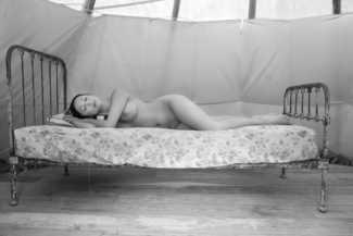 nude reclines on bed