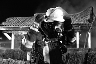Tired fireman with respirator