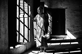 A portrait of an old monk next to window A portrait of an old monk next to window