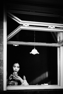 A girl sitting by window