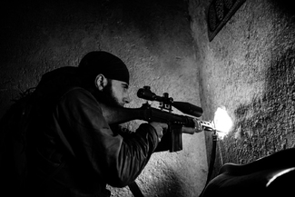 YPG Fighter aims his rifle YPG Fighter aims his rifle