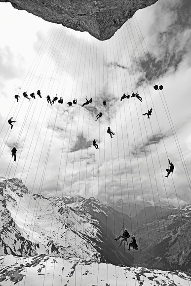 Climbers hanging on ropes